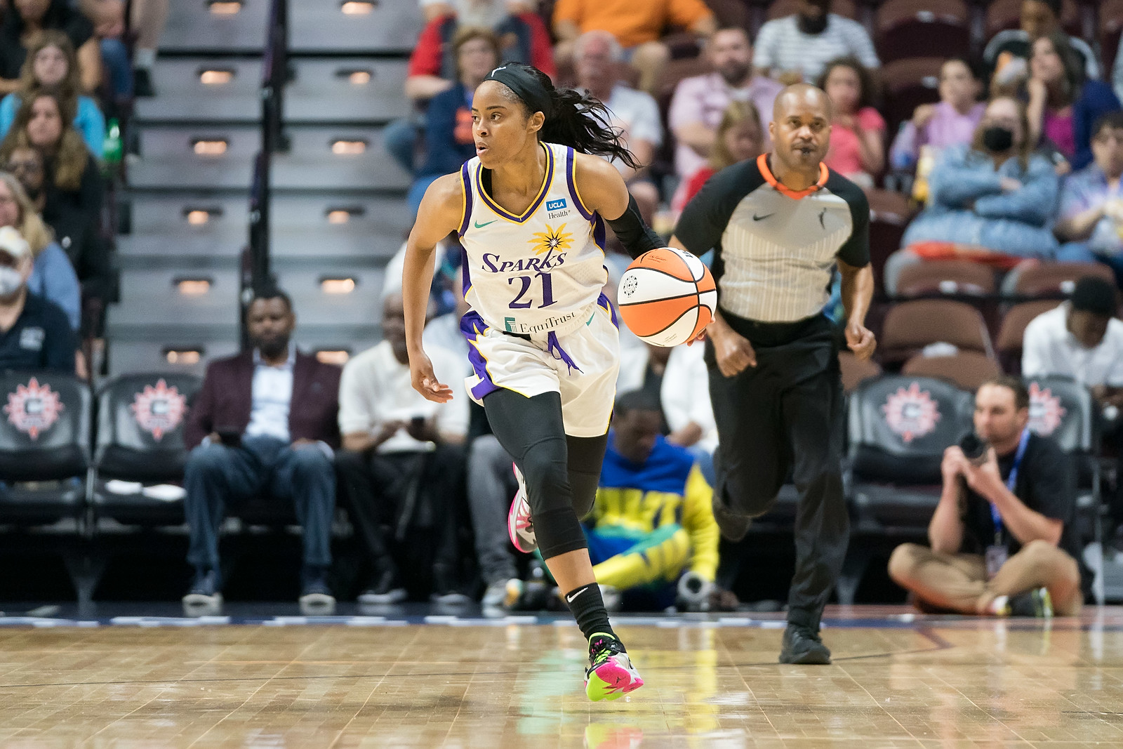 Los Angeles Sparks point guard Jordin Canada dribbles up the court while looking upcourt
