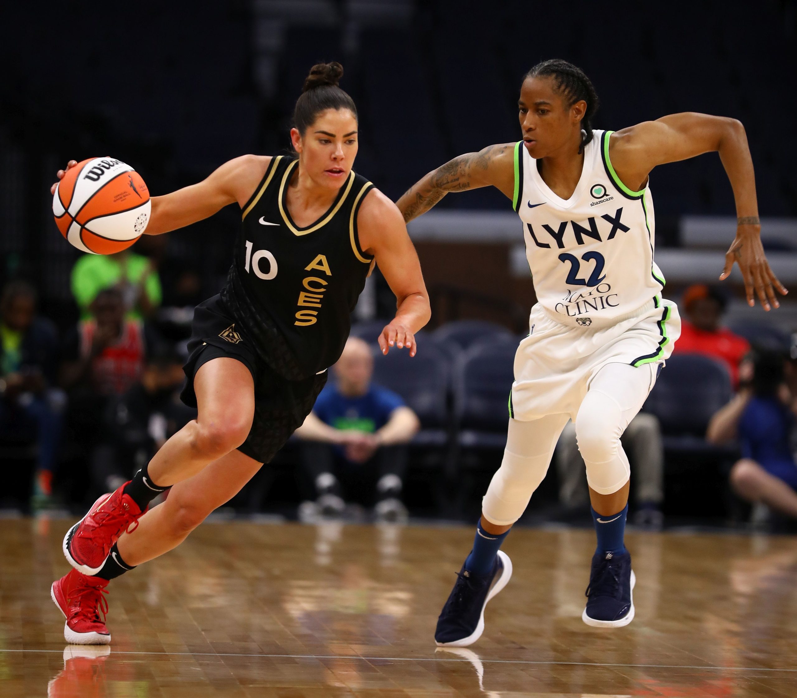 Las Vegas Aces point guard Kelsey Plum drives past midcourt, past Minnesota Lynx combo guard Yvonne Anderson