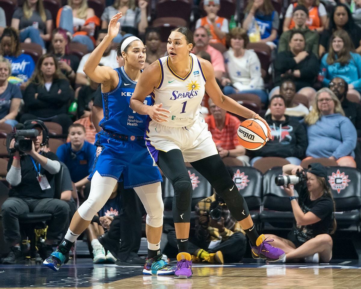 Los Angeles Sparks center Liz Cambage dribbles while posting-up Connecticut Sun center Brionna Jones in the low post