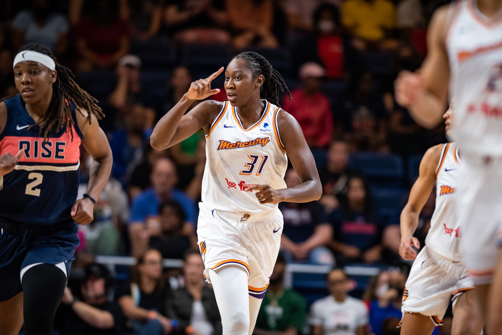 Phoenix Mercury center Tina Charles points up the court while jogging upcourt
