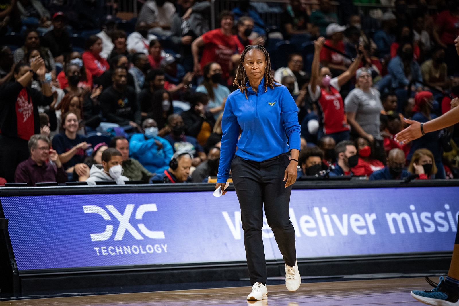 Dallas Wings head coach Vickie Johnson walks down the sideline past mid-court, with a serious expression