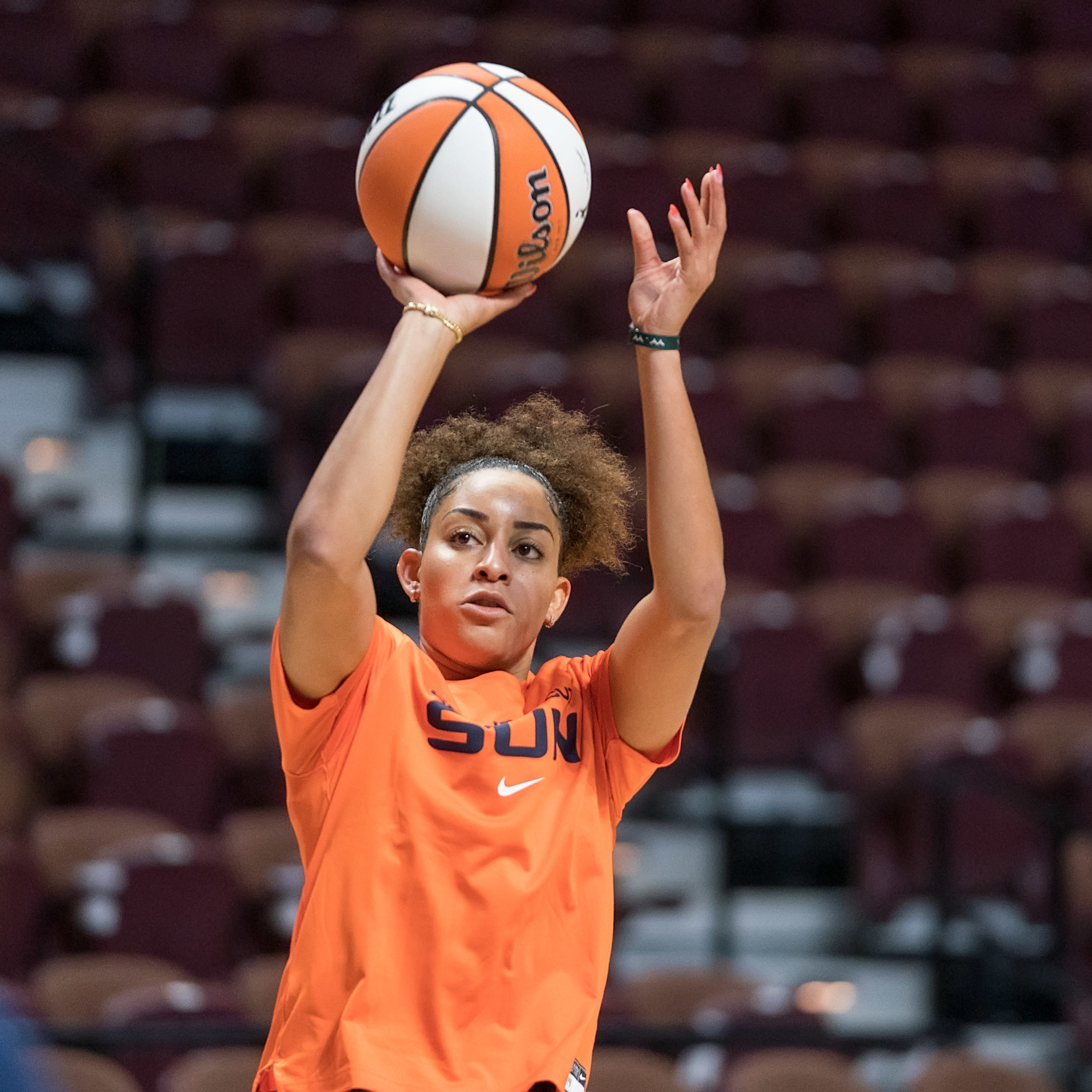 Bria Hartley wears a Connecticut Sun warm-up shirt and takes a right-handed jump shot.