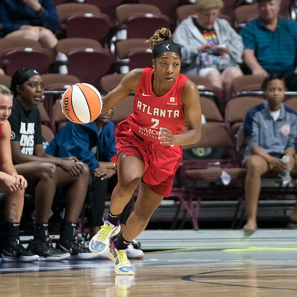 Atlanta Dream point guard Aari McDonald runs up the arc from the slot to the key while dribbling