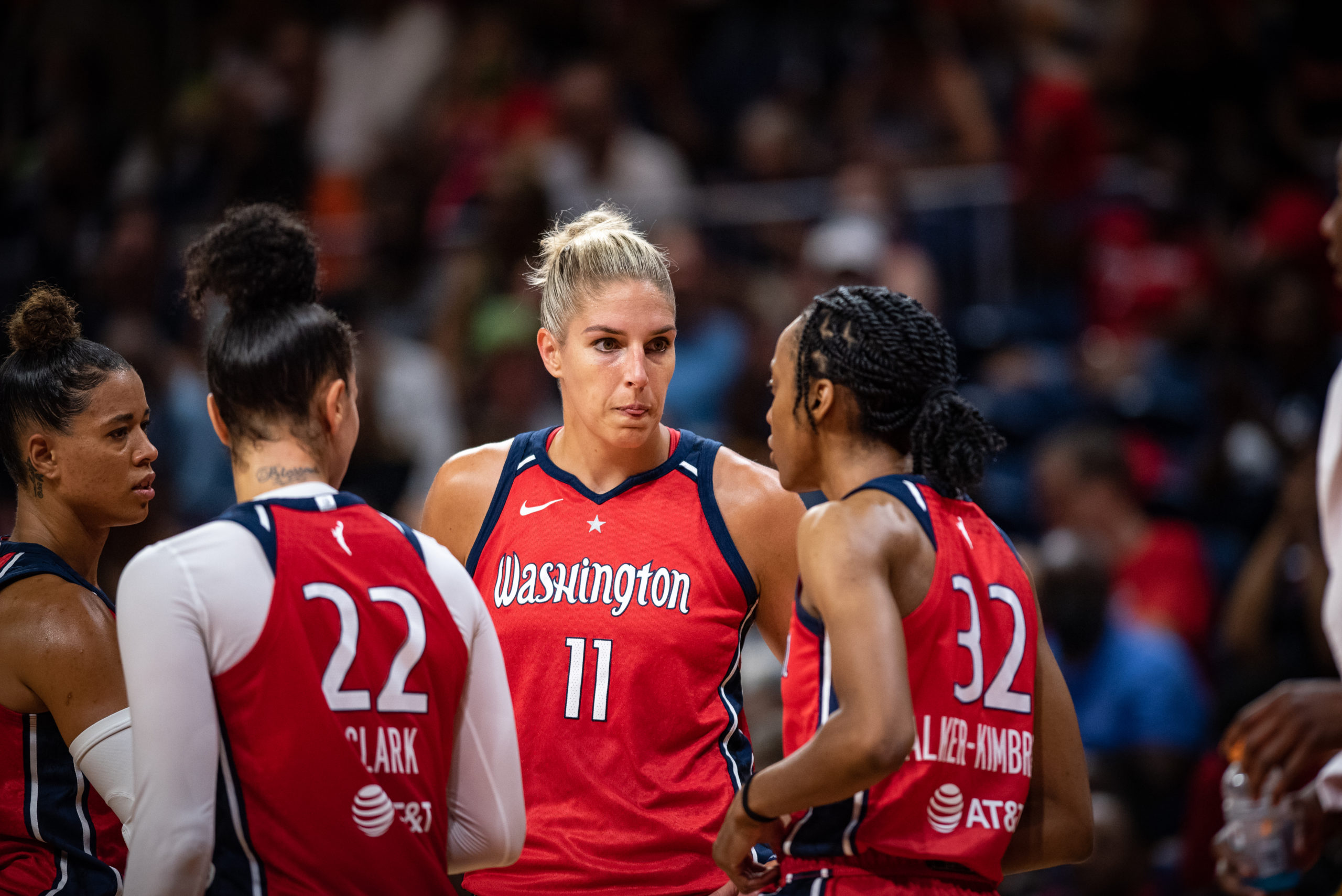 Washington Mystics players Natasha Cloud (far left), Alysha Clark (22), Elena Delle Donne (11) and Shatori Walker-Kimbrough (32) confer during a game against the Minnesota Lynx at the Entertainment and Sports Arena in Washington, D.C., on July 17, 2022. (Photo credit: Domenic Allegra)