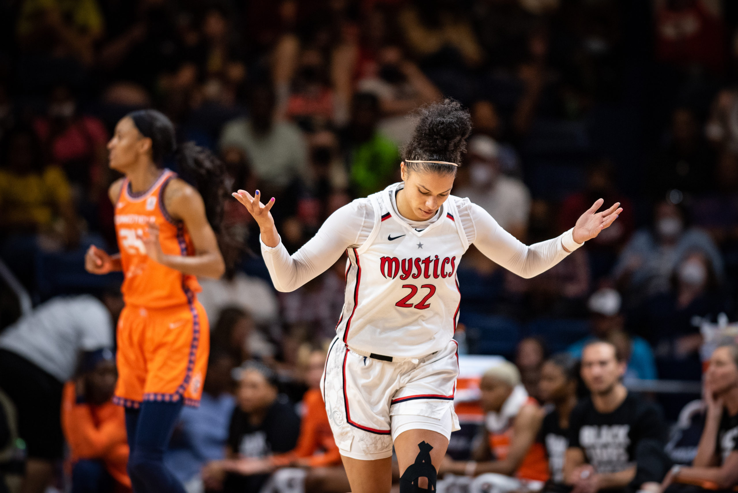 Washington Mystics wing Alysha Clark runs with her palms facing the sky during a game against the Connecticut Sun at the Entertainment and Sports Arena in Washington, D.C., on June 19, 2022. (Photo credit: Domenic Allegra)
