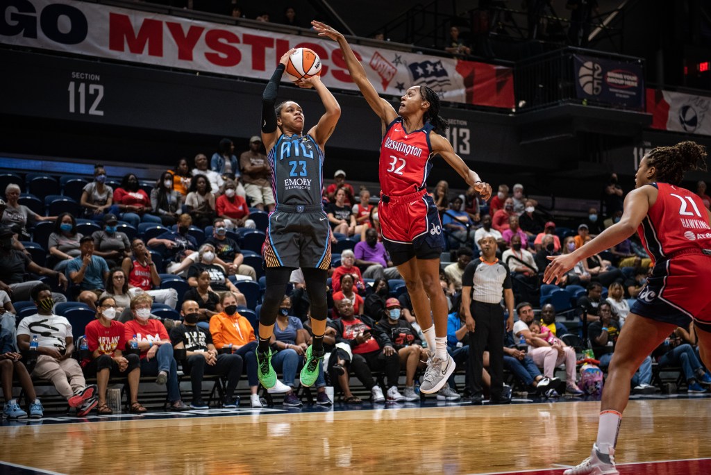 Washington Mystics guard Shatori Walker-Kimbrough (32) contests a shot by Atlanta Dream guard AD (23) during a game on June 28, 2022. (Photo credit: Domenic Allegra)