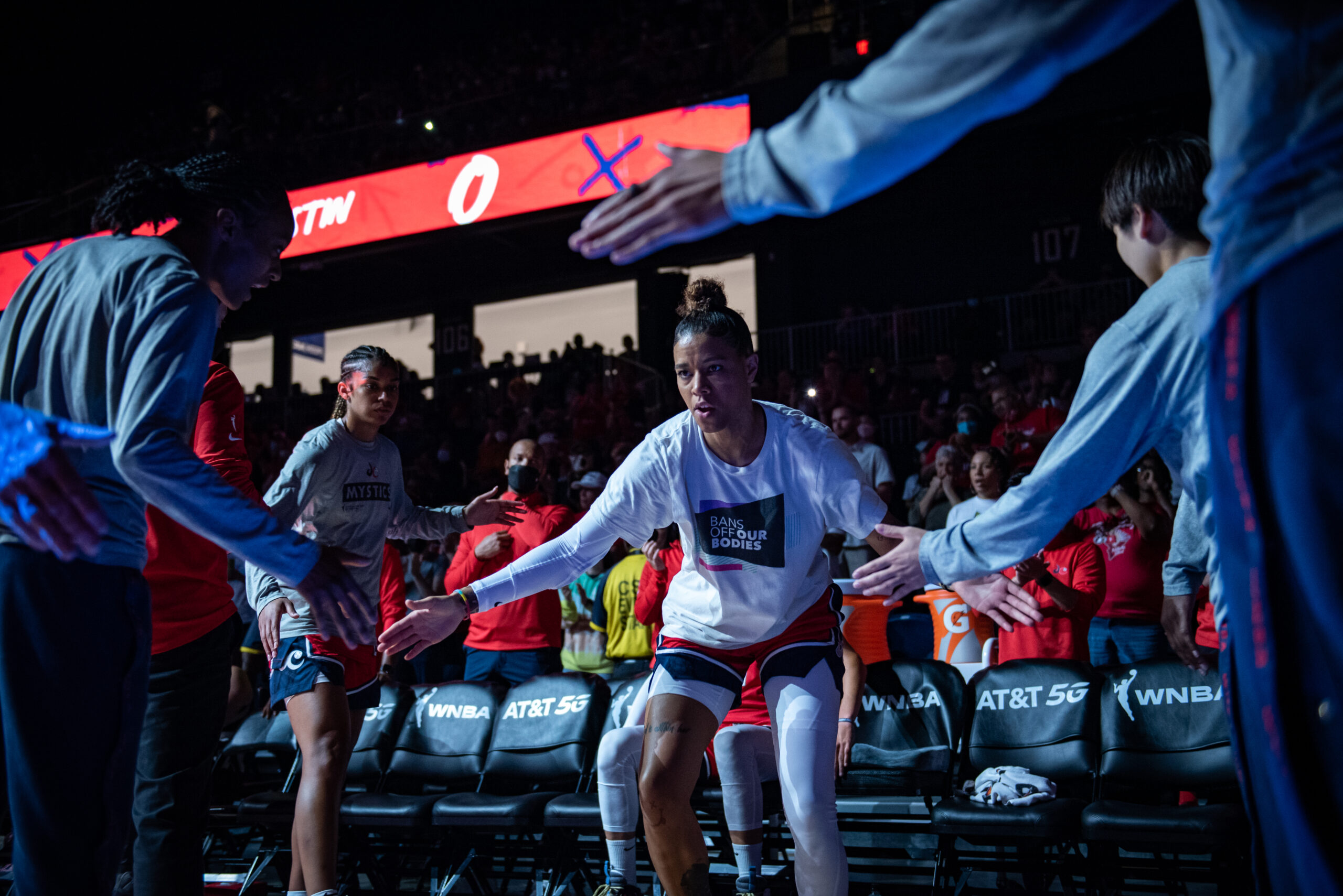 Washington Mystics point guard Natasha Cloud high-fives her teammates as she is introduced in the starting lineup before a game against the Seattle Storm at the Entertainment and Sports Arena in Washington, D.C., on July 30, 2022. (Photo credit: Domenic Allegra)