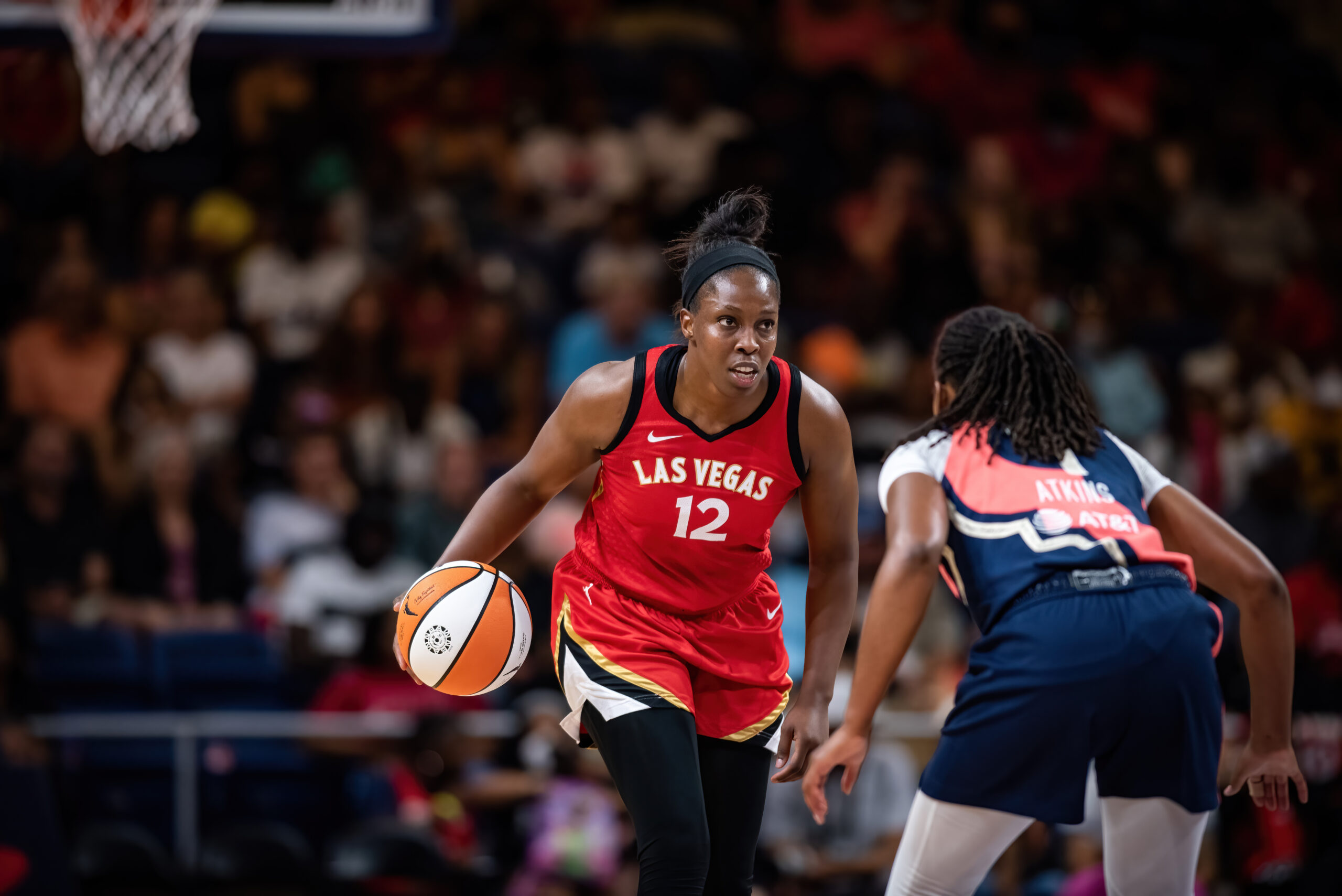 Las Vegas Aces guard Chelsea Gray dribbles the ball as Washington Mystics guard Ariel Atkins defends.