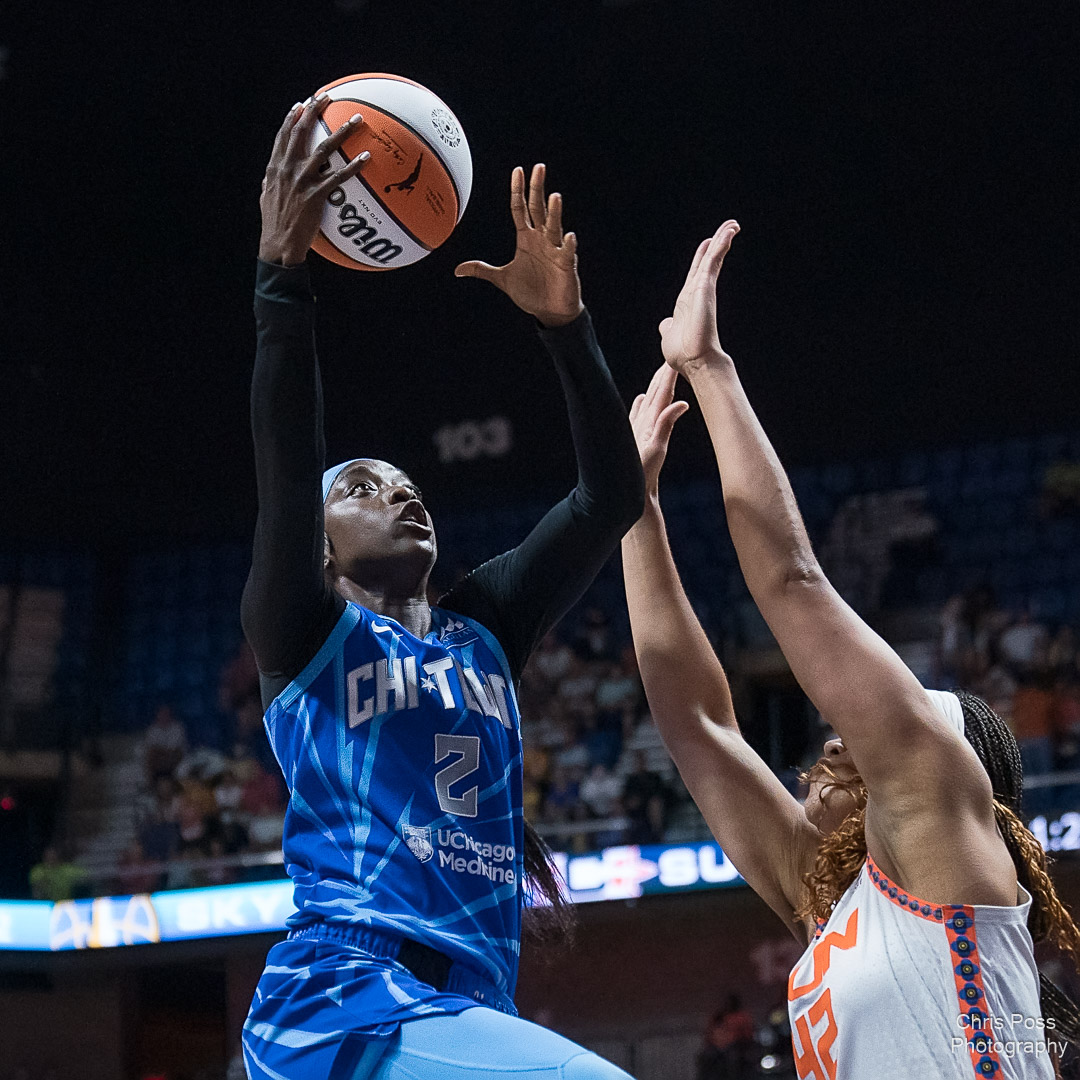 Sky wing Kahleah Copper (2) goes for a layup over Sun center Brionna Jones (42). Jones has both of her arms outstreched to contest the layup.