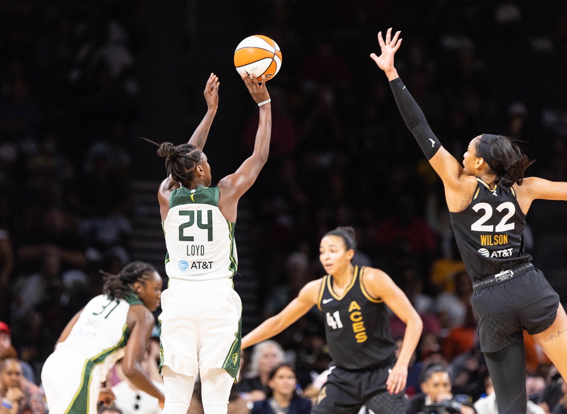 Seattle Storm combo guard Jewell Loyd releases a long jumper off her fingertips as Las Vegas Aces center A'ja Wilson jumps towards her with a raised hand and outstretched arm to try to contest the shot