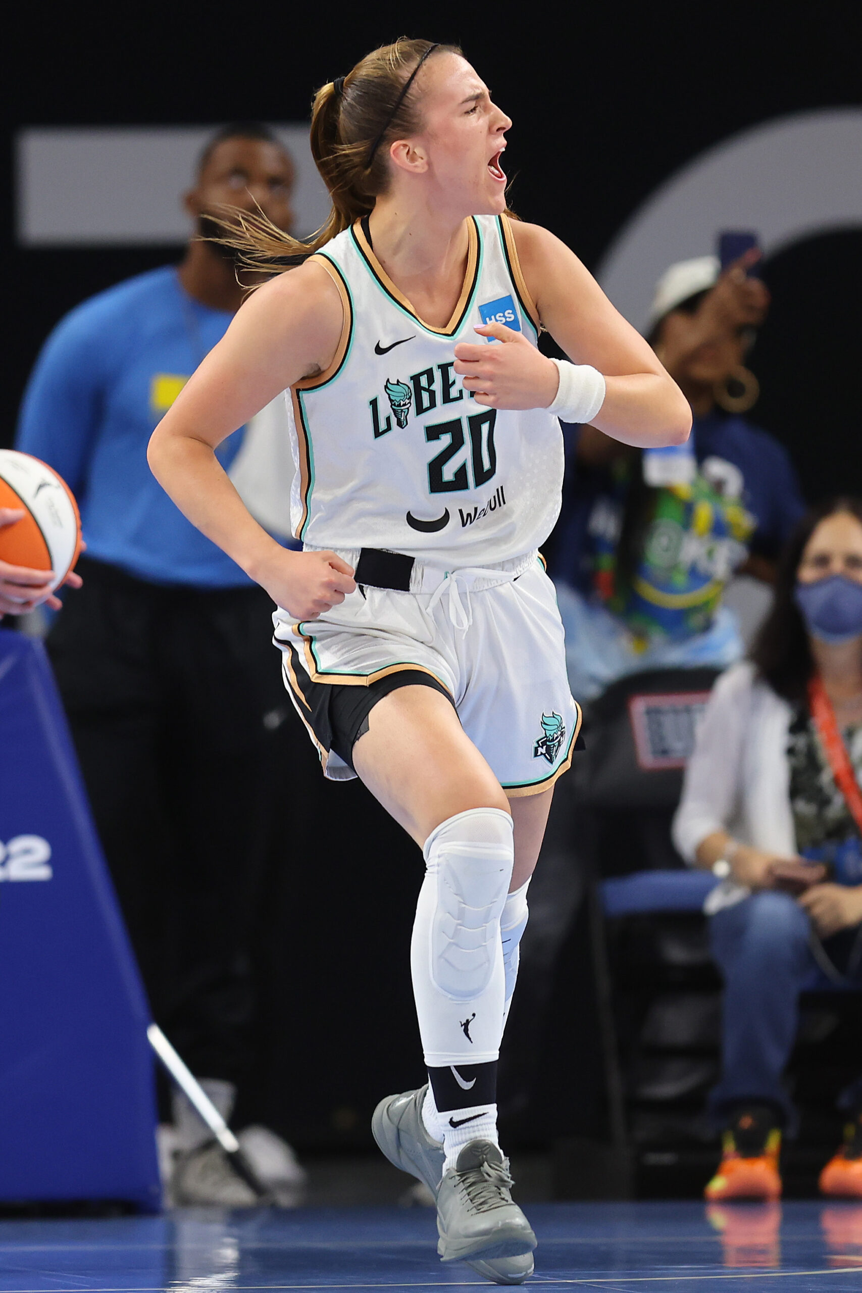 New York Liberty combo guard Sabrina Ionescu runs up the court while looking towards the sideline, beating her chest, and yelling in celebration