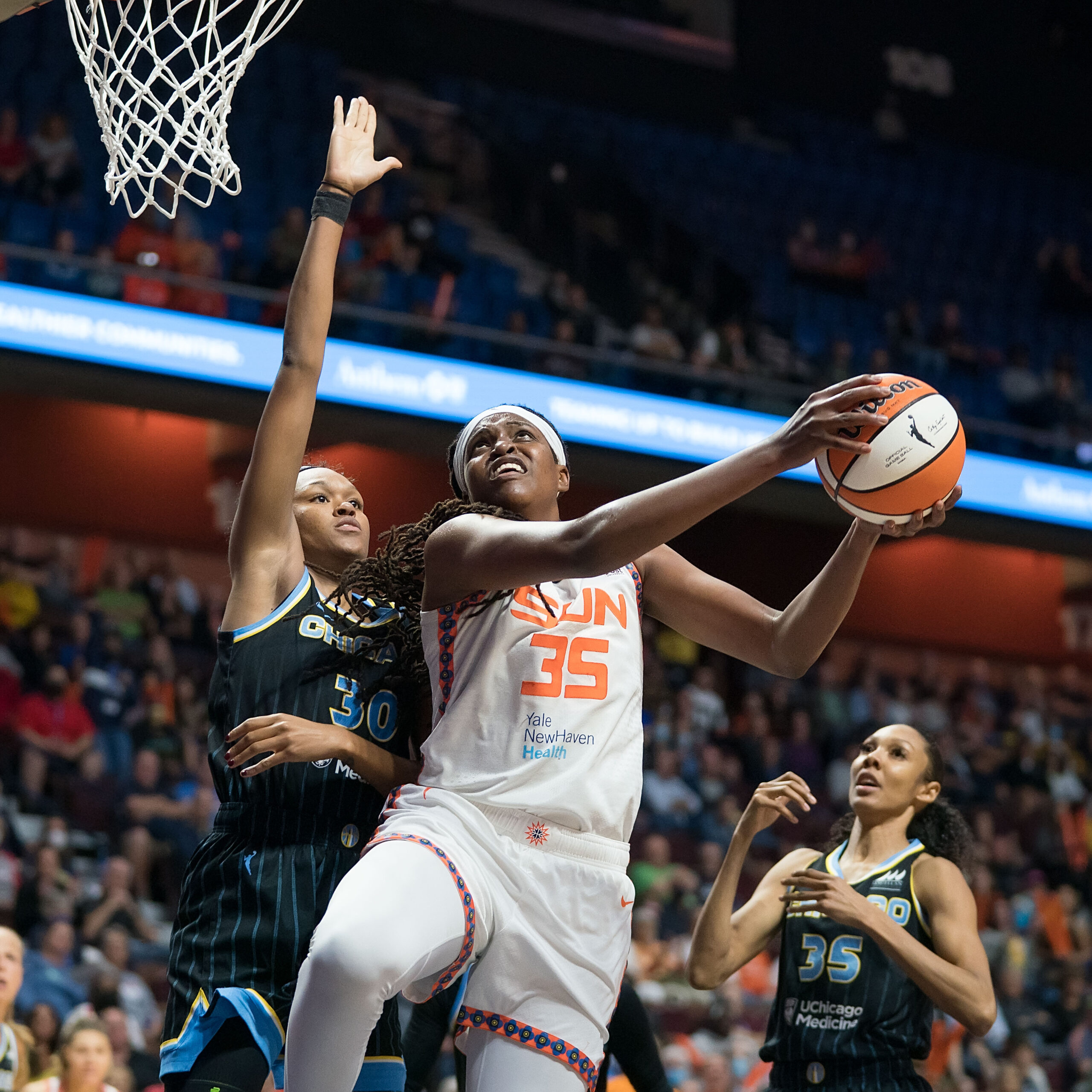 Sun big Jonquel Jones (35) goes for a layup as Sky big Azura Stevens (35) defends.