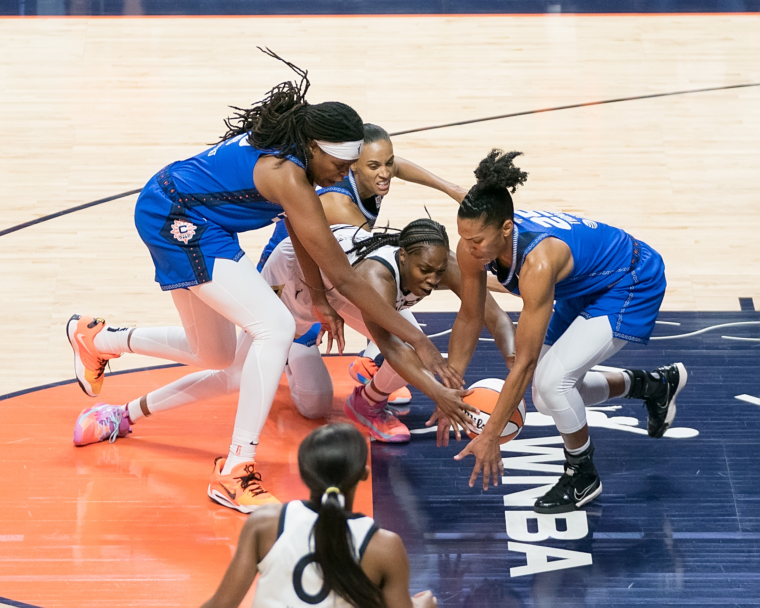 Connecticut Sun center Jonquel Jones, Las Vegas Aces guard Chelsea Gray and Connecticut Sun forward Alyssa Thomas fight for a loose ball.