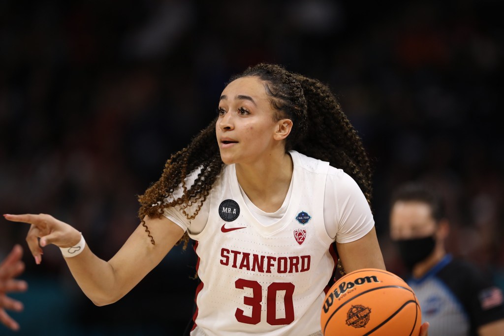 Stanford's Haley Jones handles the ball and points during a game against the University of Connecticut.