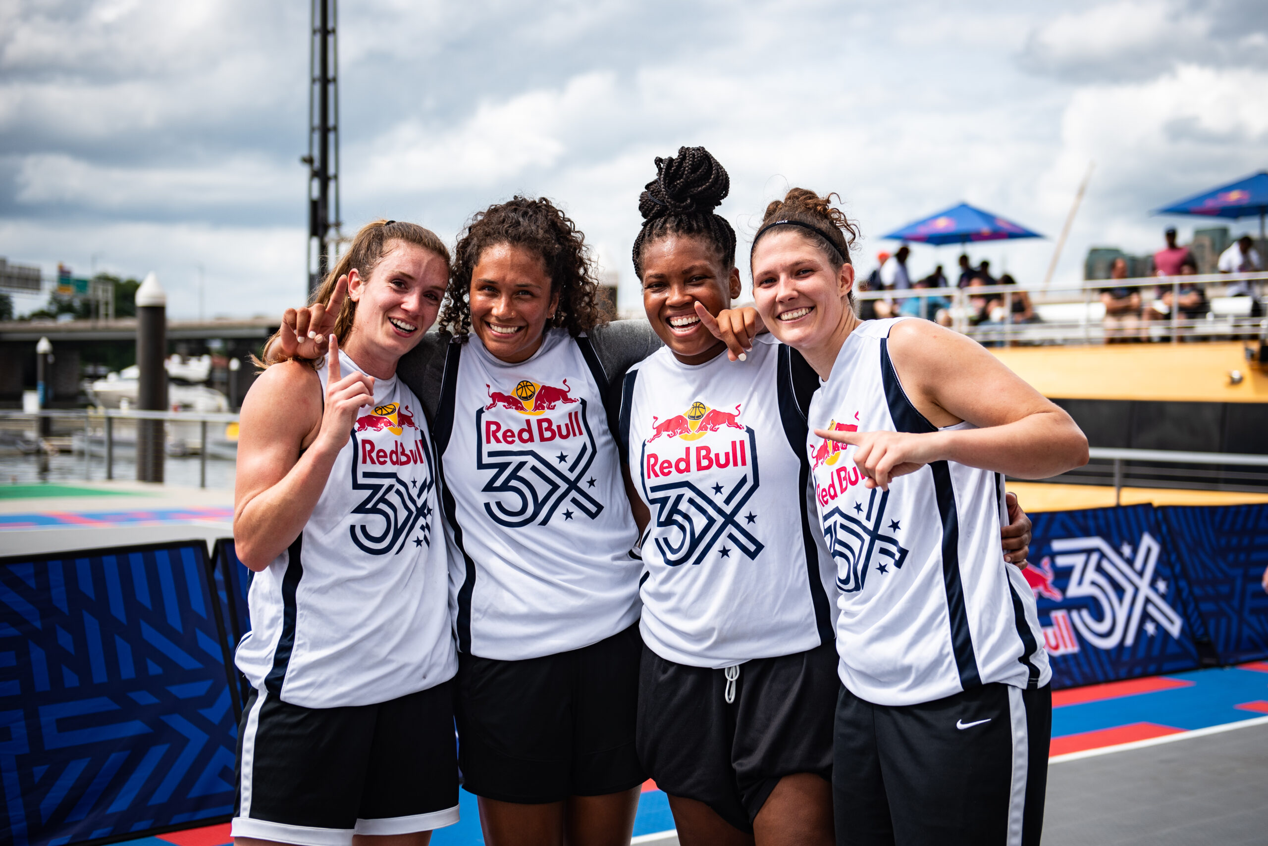 Blake Dietrick, Lakin Roland, Leslie Robinson and Camille Zimmerman hold up one finger to celebrate winning a Red Bull 3x3 event.