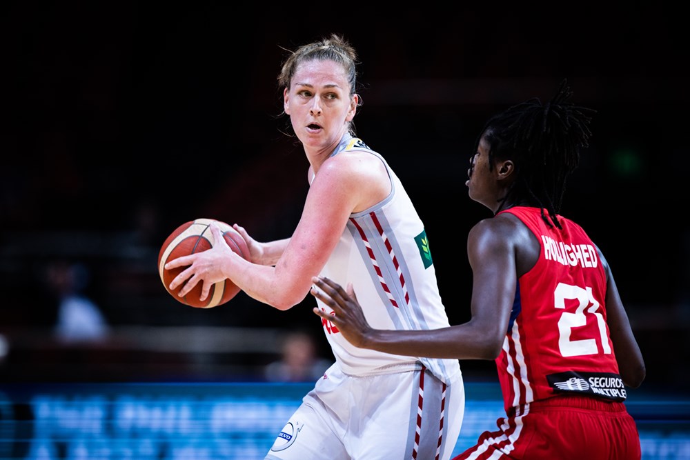 Belgium's Emma Meesseman (11) gathers the ball as Puerto Rico's Mya Hollingshed (21) defends. Meesseman plays for Fenerbahçe.