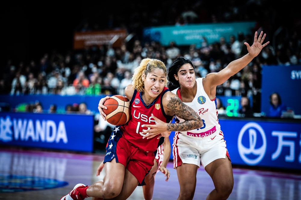 Shakira Austin of the United States drives past Nairimar Vargas of Puerto Rico.