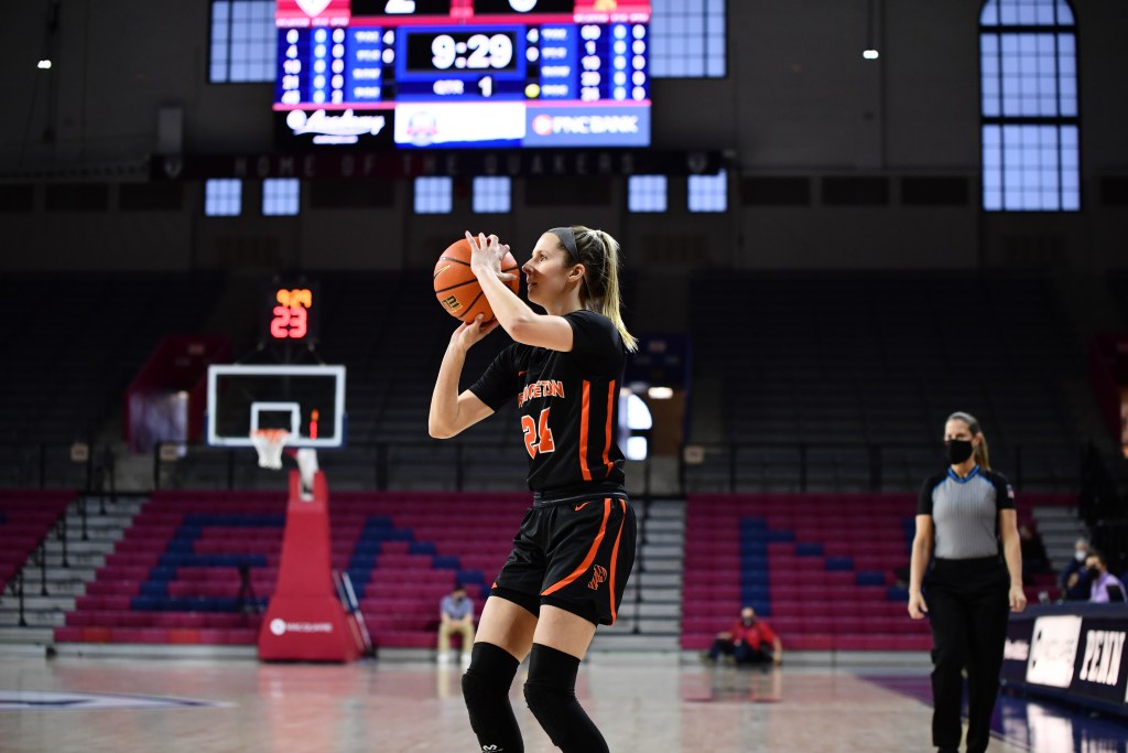 A photo in profile of Princeton guard Julia Cunningham shooting the ball.