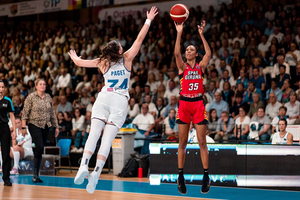 Spar Girona's Rebekah Gardner (35) shoots over Basket Landes' Marie-Eve Paget (74), who contests the shot with an outstretched right hand.