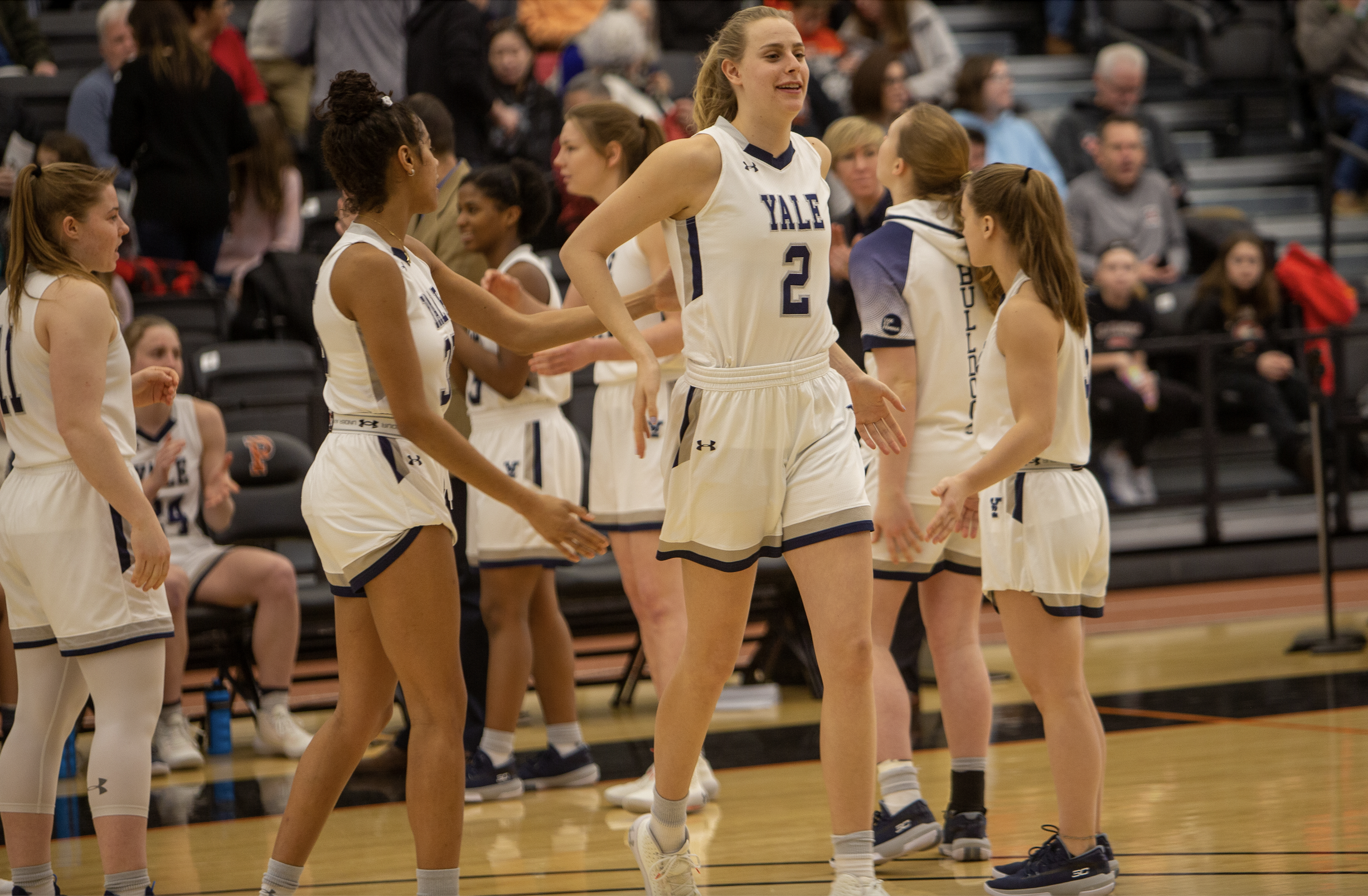 Yale forward Camilla Emsbo (2) low-fives her teammates as she is introduced in the starting lineup.