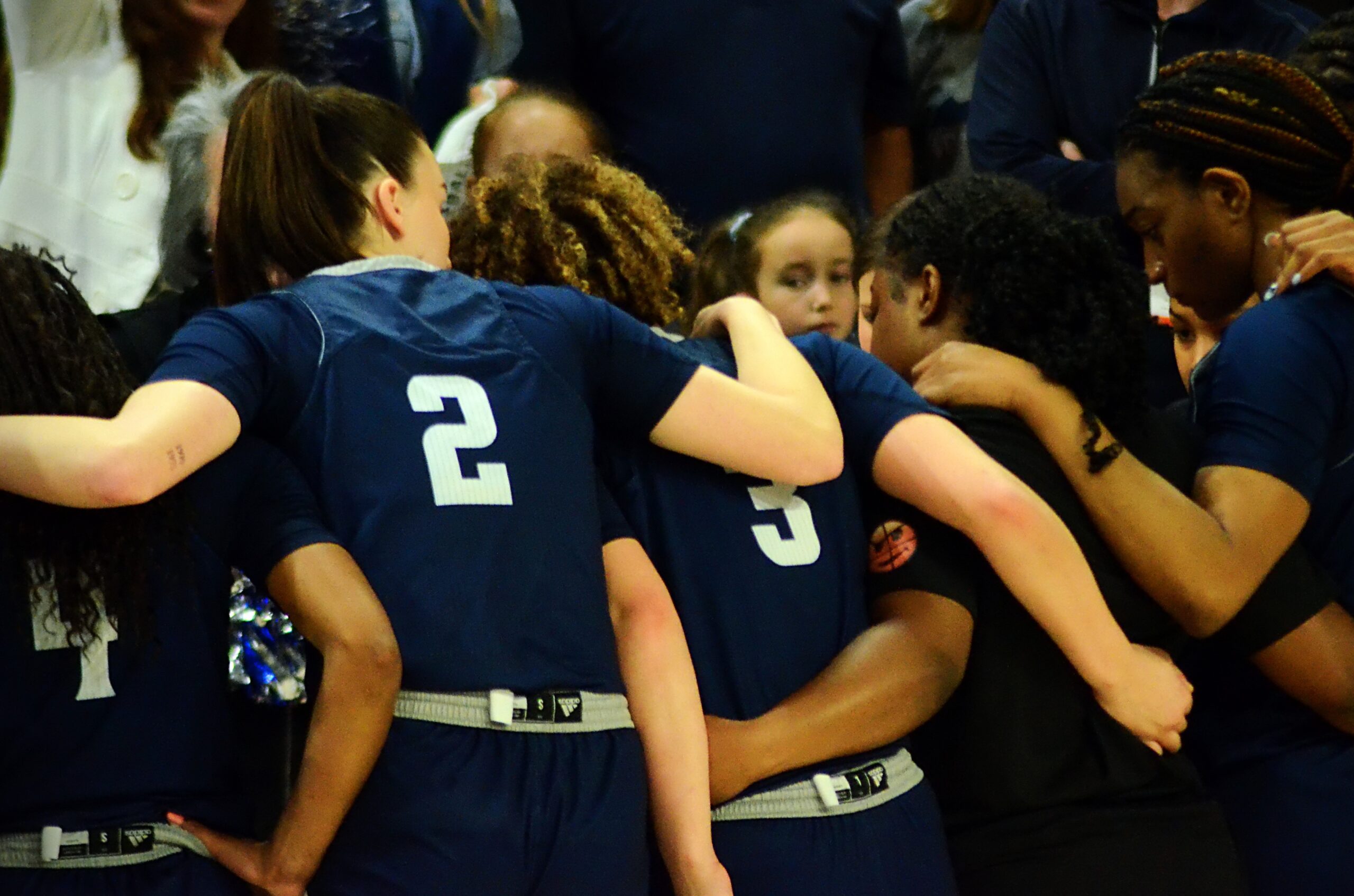 Longwood players huddle on near the bench