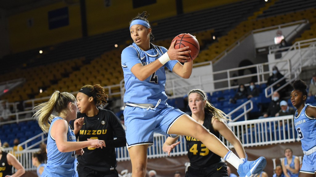 Columbia guard/forward Kaitlyn Davis controls the ball, grabbing it with both hands.