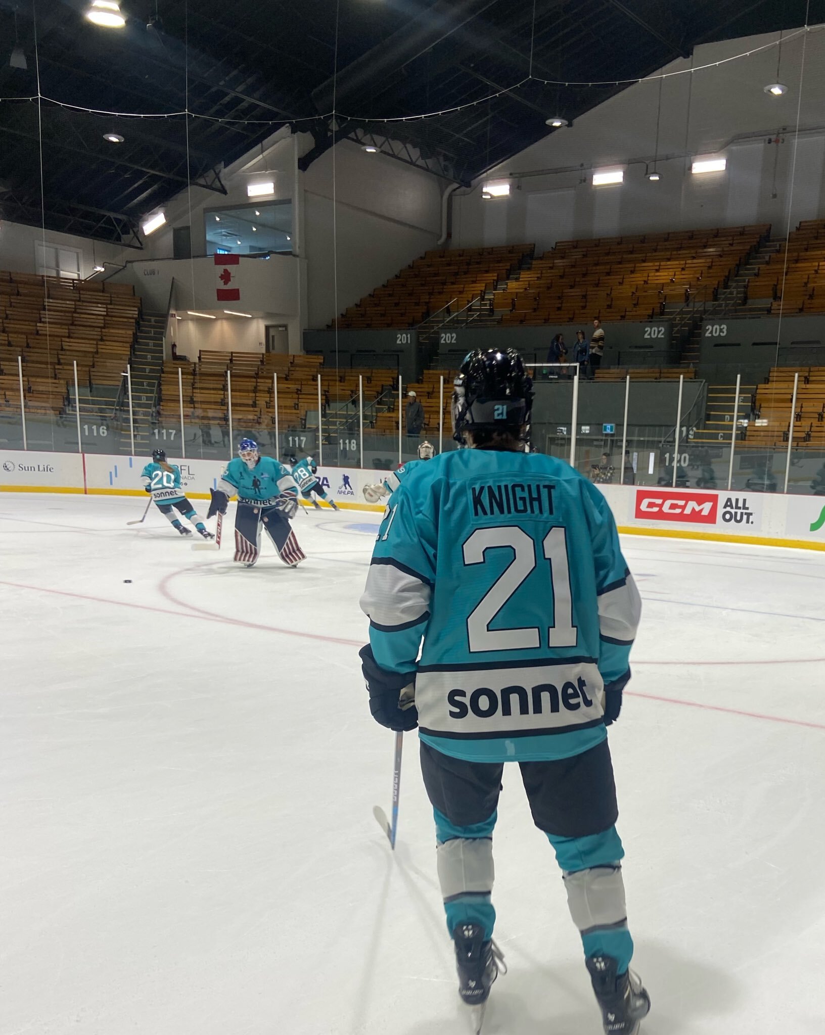 Sonnet player number 21 looks on during hockey action.