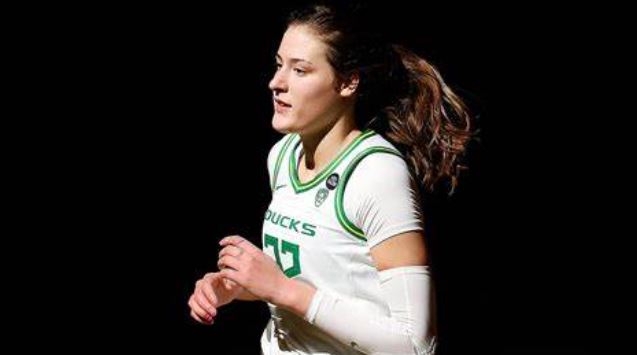 Sedona Prince in an Oregon uniform running onto the court.