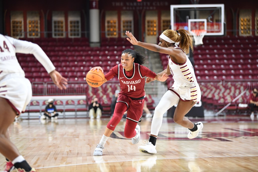 Harvard guard Harmoni Turner tries to attack off the dribble from near the top of the key as a Boston College defender tries to cut off her driving lane.