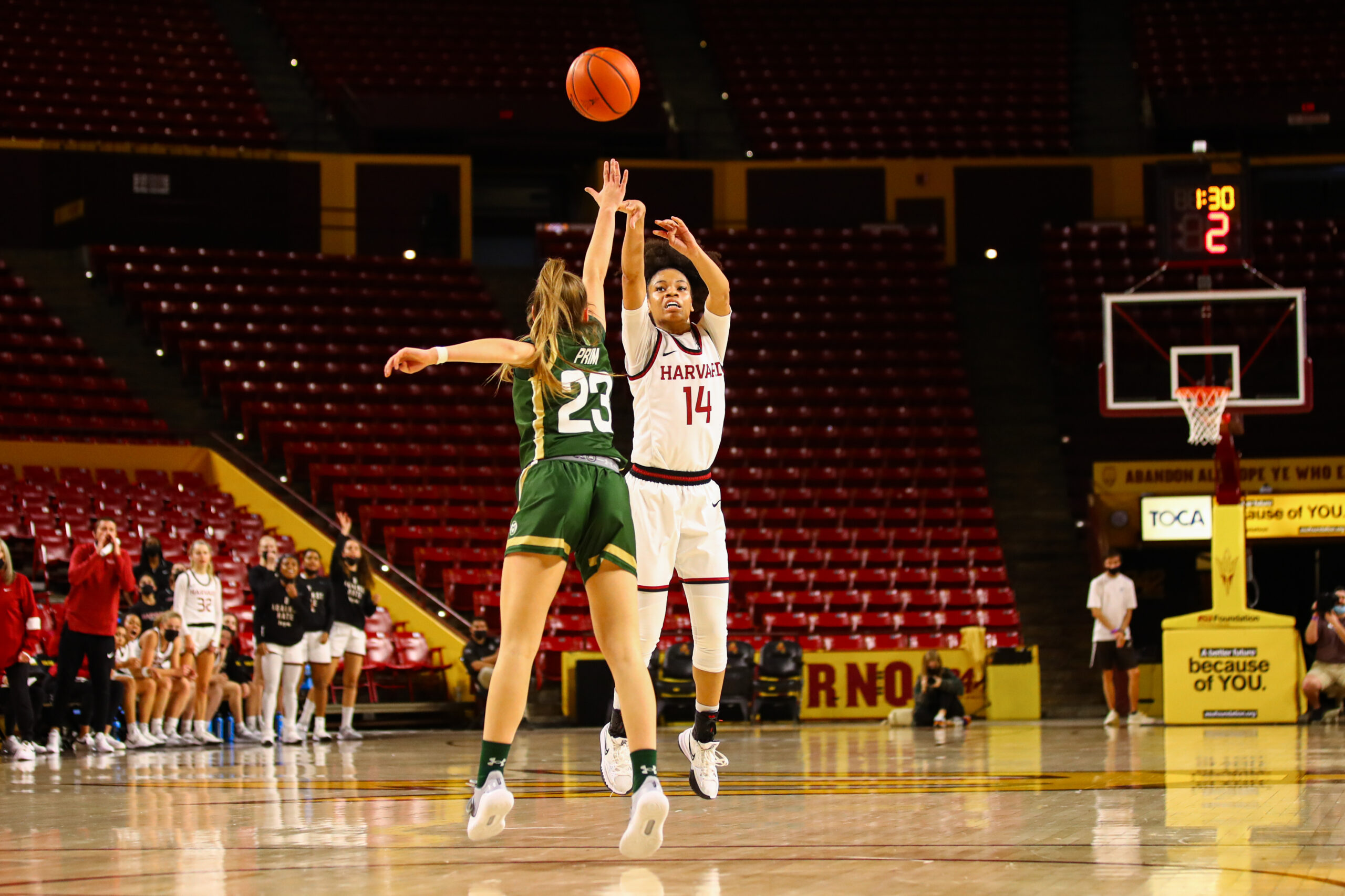 Harvard point guard Harmoni Turner shoots from near the 3-point line as a defender closes out on her.