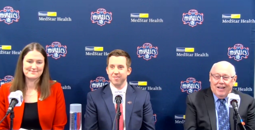Washington Mystics assistant general manager and senior vice president of strategy and vision Maria Giovannetti (left), head coach Eric Thibault (center) and general manager Mike Thibault smile during a press conference