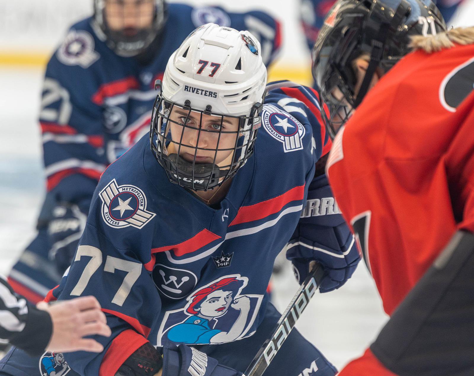 Photo of Riveters forward Kennedy Ganser in red, white and blue uniform with Riveters logo.