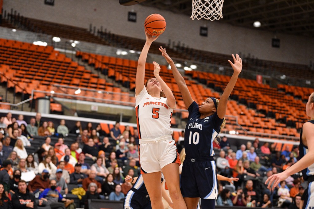 Princeton forward Paige Morton attempts a close-range shot with her right hand, fading away slightly as a Villanova defender contests the shot.