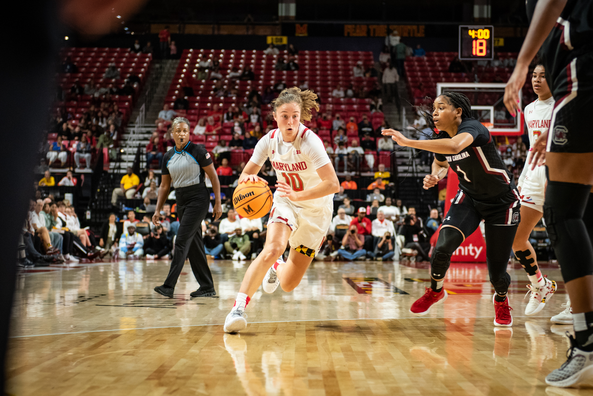 Maryland guard Abby Meyers drives to the basket with her right hand as South Carolina guard Zia Cooke tries to stay with her in the lane.