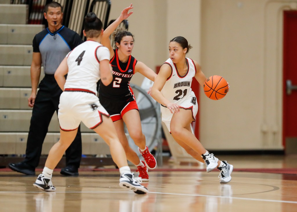 Brown guard Grace Arnolie uses a screen set by her teammate to drive left.