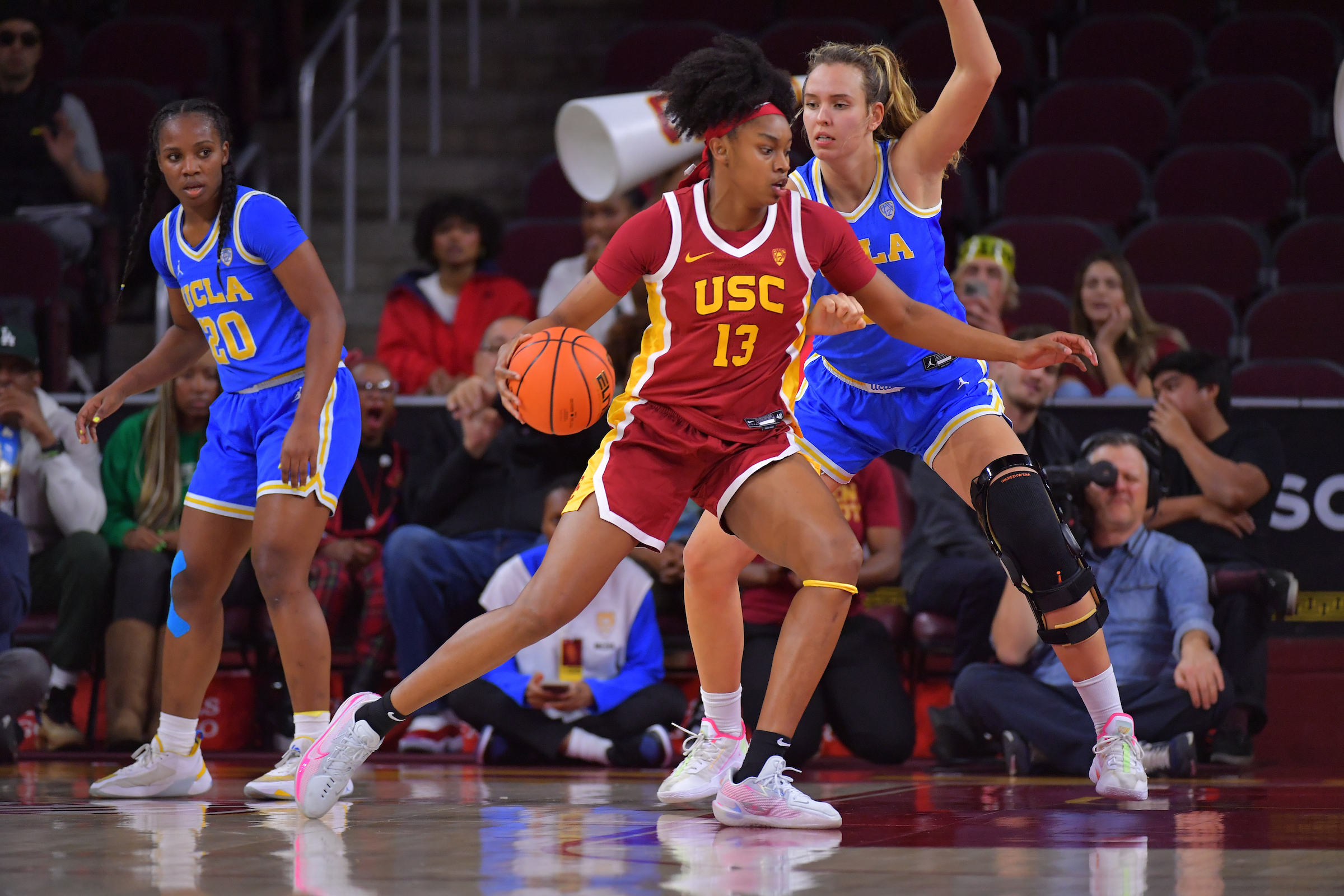 USC guard/forward Rayah Marshall dribbles the ball with her right hand as a UCLA defender tries to wall up.