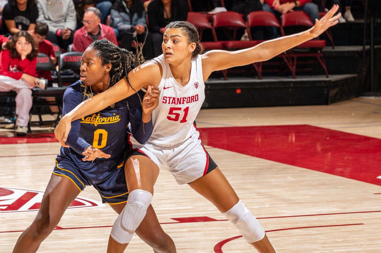 Stanford's Lauren Betts is pictured driving to the basked against Cal's Ugonne (Michelle) Onyiah.