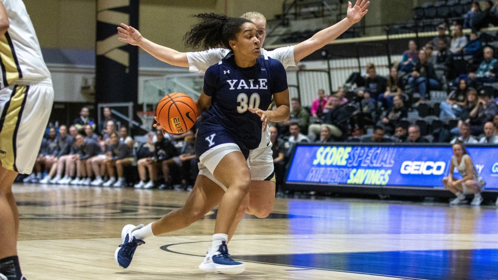 Yale guard Nyla McGill drives to the lane with her right hand. She has a step on her defender, who is trying to stay on McGill's inside.