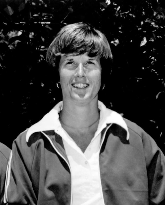 Billie Moore pictured in a black and white photo wearing a Team USA warm-up jacket as coach of the 1976 U.S. Olympic team.