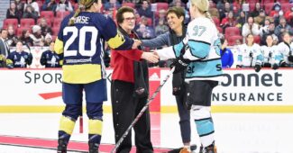 Sarah Nurse (20) shakes hands with Ilana Kloss and Rebecca Leslie (37) shakes hands with Billie Jean King at center ice.