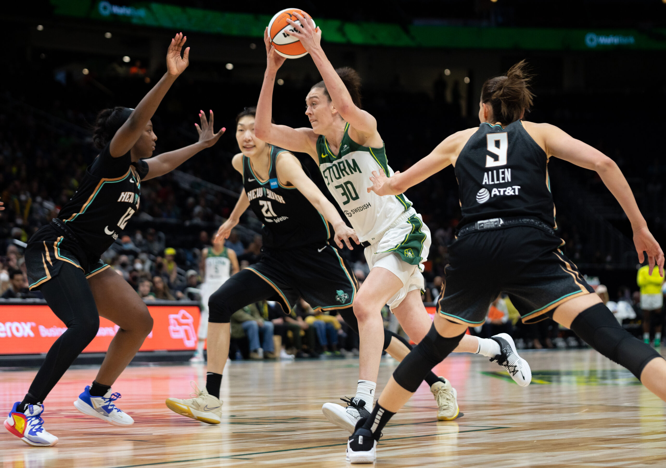Seattle Storm forward Breanna Stewart holds the ball above her head as she attacks the basket.