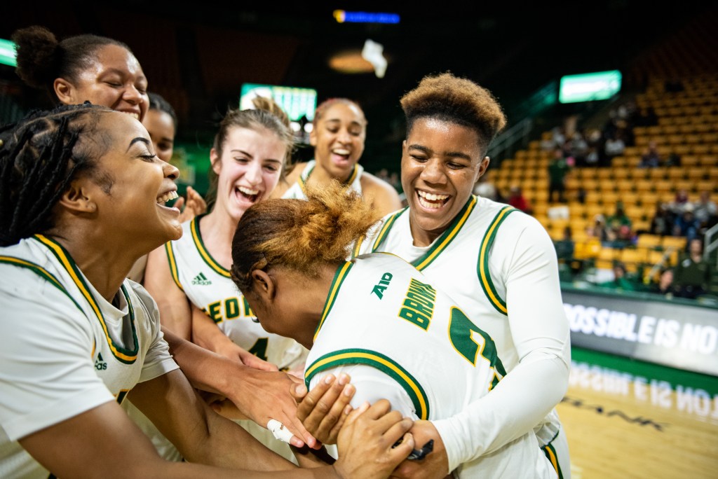 Jada Brown's teammates smiled, hugged and cheered for her after the game in which she scored her first career point.
