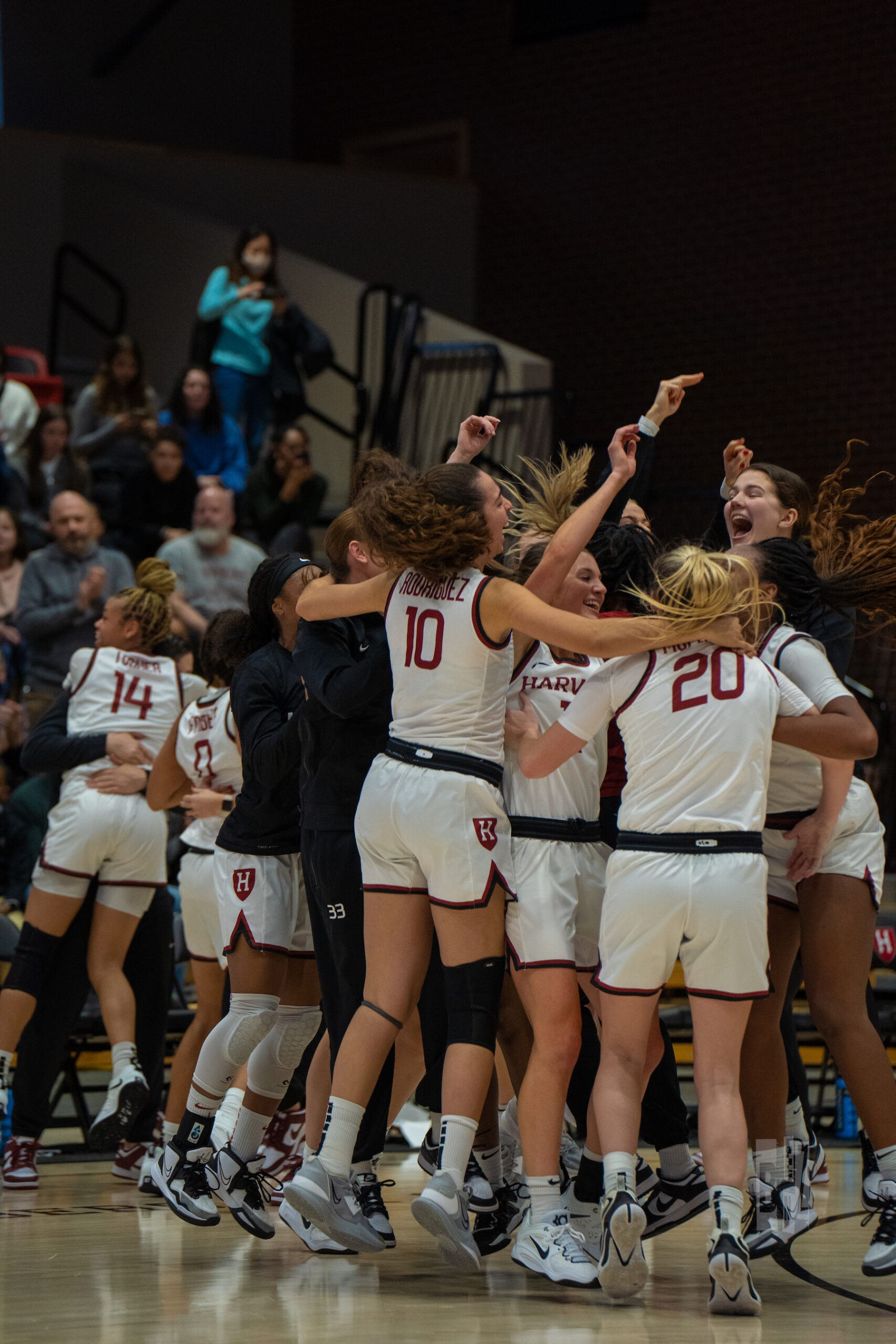 Jubilant Harvard players jump up and down in a circle after the buzzer sounded on a victory over Princeton.