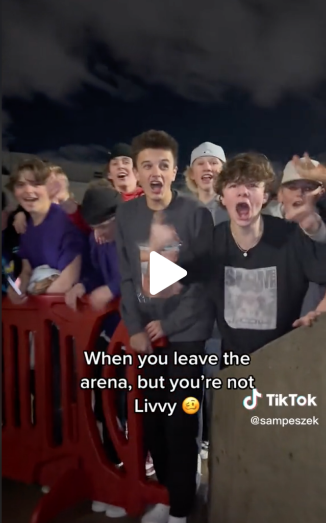 A still from a TikTok posted by Samantha Peszek showing a group of young men catcalling Livvy Dunne outside the Huntsman Arena in Salt Lake City.