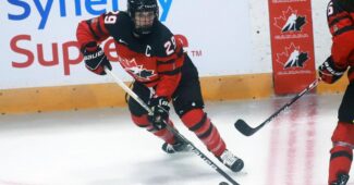 Marie-Philip Poulin skating in red and black Team Canada uniform.