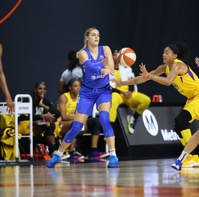 Bella Alarie passes the ball on the perimeter.