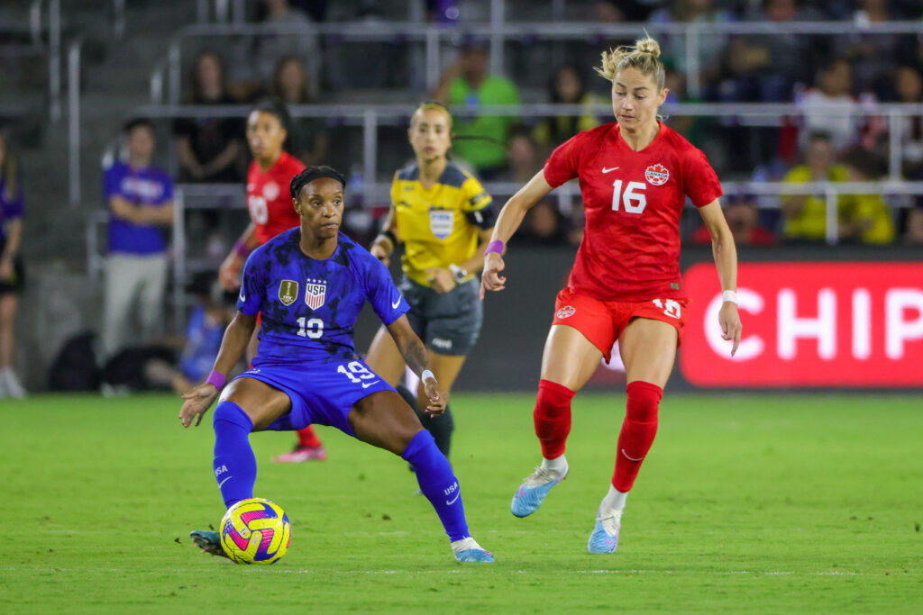 Feb 16, 2023; Orlando, Florida, USA; USA defender Crystal Dunn (19) handles the ball in front of Canada forward Janine Beckie (16) during the first half at Exploria Stadium. Mandatory Credit: Mike Watters-USA TODAY Sports