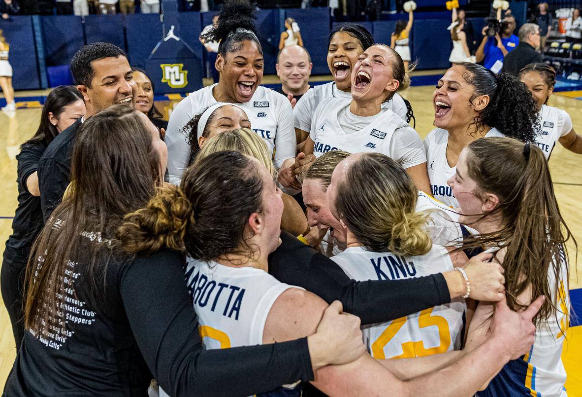 Marquette women's basketball players celebrate after a BIG EAST victory over UConn.