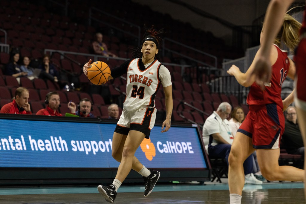 Pacific's Liz Smith dribbles the ball with her right hand and looks downcourt.