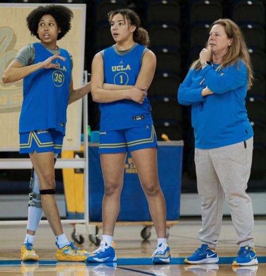 UCLA senior guard Camryn Brown (L) provides guidance to freshman guard Kiki Rice as UCLA head coach Cori Close looks on. (Photo Credit / UCLA Women's Basketball Twitter page)